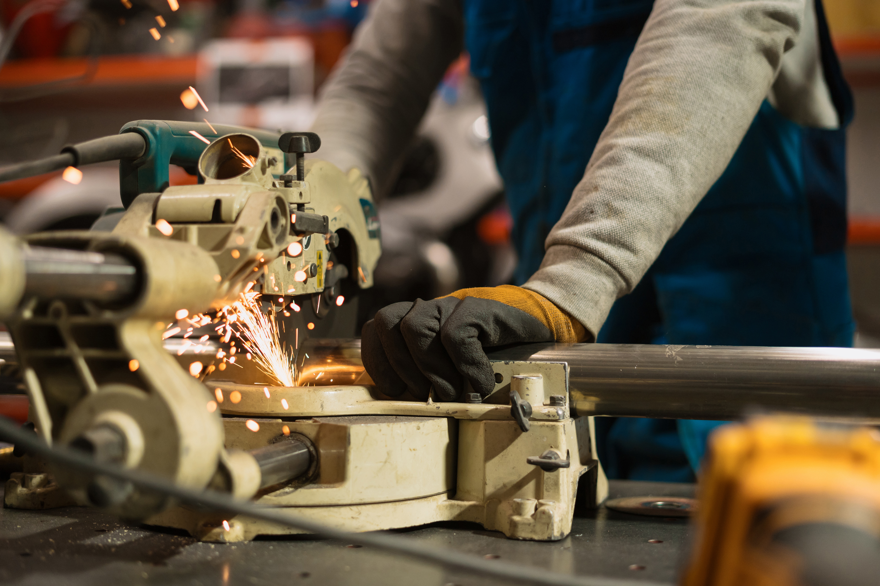 Worker working with a circular grinder on a metal with sparks Technician worker cutting metal with many sharp sparks. Using equipments to cat iron